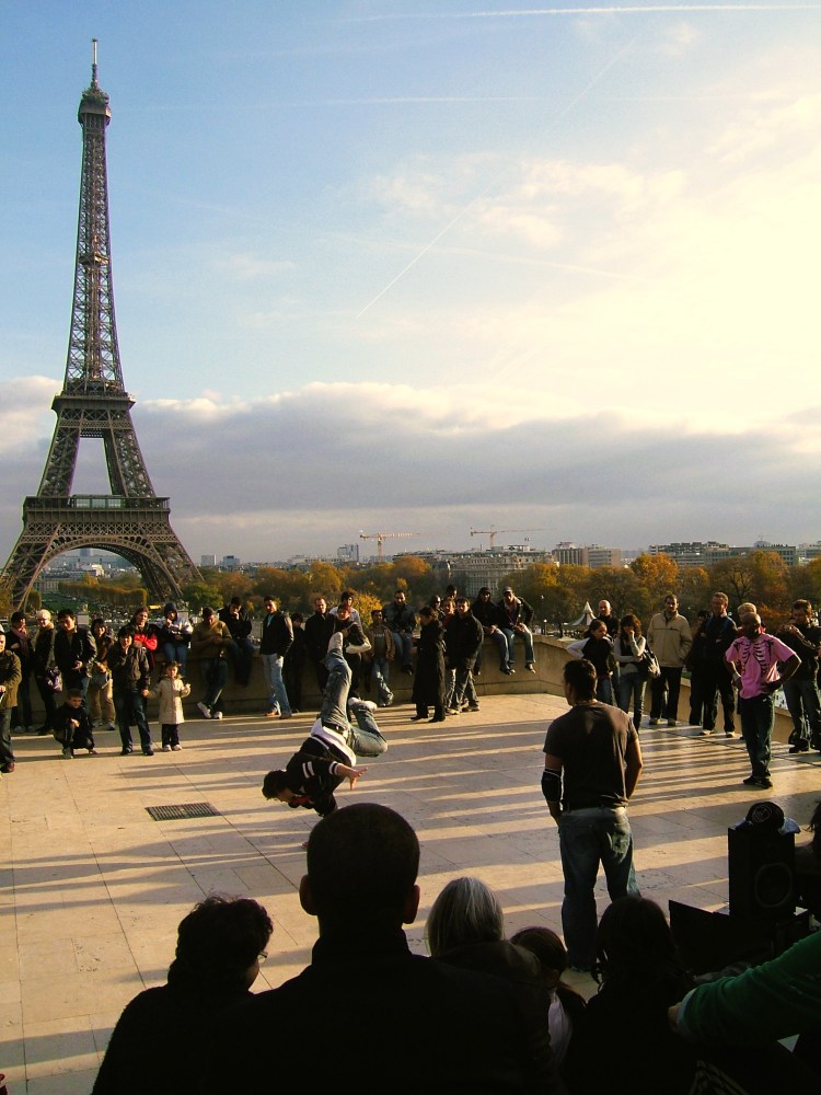 break dancing in front of the Eiffel Tower Paris France