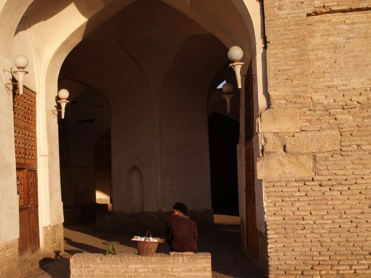 man-sitting-outside-a-covered-bazaar