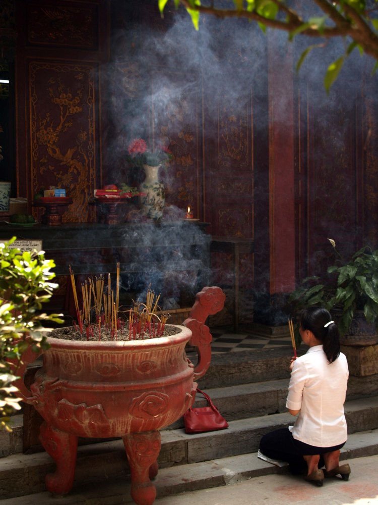 Woman kneeling at temple